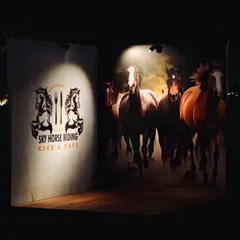 Our dedicated photo corners, like this one with dramatic lighting, provide a great spot for guests to capture memories. It adds a fun, interactive element to any evening party or gathering.