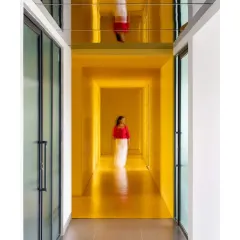 For the Amber Encase clubhouse, I used a bold, monochromatic yellow to create an immersive and energetic corridor. The reflective ceiling doubles the impact of the color, making the space feel endless and dynamic.