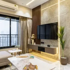 This TV unit space epitomizes understated luxury, blending rich textures with sleek functionality. The marble-clad backdrop and ambient vertical lighting emphasize elegance while creating a visually expansive effect, adding utility and fluidity to the urban sophistication of the space.