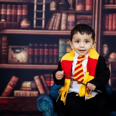 For the little wizards and witches, I bring the magic of Hogwarts to life. This Harry Potter themed shoot is one of my most requested setups, complete with a Gryffindor scarf, a magic wand, and a library backdrop for a truly enchanting portrait.