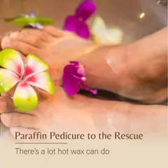 A close-up of feet soaking in a warm paraffin wax bath, infused with floral elements. This treatment provides intense moisture, especially beneficial during dry winter months.