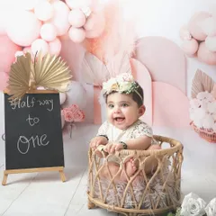 Halfway to one is a milestone worth celebrating. This adorable half-birthday shoot features a beautiful pink boho theme with a custom chalkboard sign to mark the special occasion.