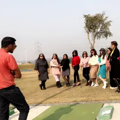 A group of women enjoys an introductory golf lesson. It's a perfect plan for a fun and different kind of girls' day out.