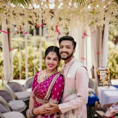 A happy couple posing for a photo at their outdoor engagement ceremony.