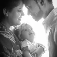 I love using light and shadow to create artistic and emotional portraits. This black and white image captures an intimate, quiet moment between new parents and their baby, focusing on their bond without any distractions.
