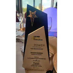 A close-up of the "Her Power" award from The Brand Story. This trophy is a reminder to keep pushing boundaries and celebrating the power of dance and women's empowerment.