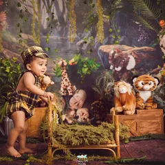 Welcome to the jungle. This adventurous setup features a lush backdrop, a tiny cot, and a whole crew of friendly stuffed animals for your little explorer.