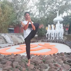 Practicing a one-legged balancing asana before the sacred symbol 'Om' reminds us of our connection to the universe. Yoga helps us build immunity not just by strengthening the body, but by reducing the stress hormones that compromise our well-being.