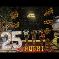 An elegant outdoor 25th birthday celebration by the pool. We used a black sequin wall, gold and black balloons, and marquee lights to create a sophisticated and memorable party atmosphere at night.