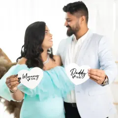 Announcing the journey to parenthood with cute, heart-shaped 'Mommy to be' and 'Daddy to be' signs. This is a fun way to add a personal touch to your maternity announcement photos.
