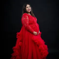 A classic solo portrait in our dramatic red gown. The long sleeves with lace detail and the voluminous skirt create a look of pure elegance against the dark backdrop.
