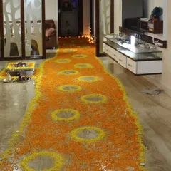 A welcome home surprise should be grand. I designed this beautiful floral pathway using fresh marigold petals in orange and yellow, leading up to the main event area and creating a traditional and heartfelt entrance.