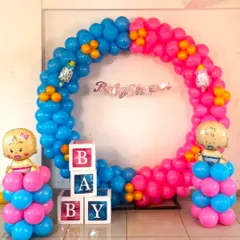 A classic 'boy or girl' themed baby shower balloon ring. The decoration uses pink and blue balloons, 'BABY' blocks, and baby-shaped foil balloons.