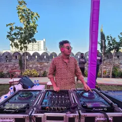 DJing outdoors at a beautiful venue in Udaipur. I adapt my music style to fit the daytime vibe, creating a relaxed yet energetic atmosphere perfect for a Haldi or Mehendi.
