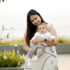 A tender moment between a mother and her baby during an outdoor rooftop shoot. The soft, natural light is perfect for these gentle portraits.