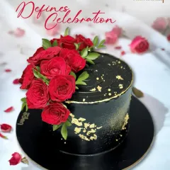 A cake that defines celebration. This stunning black cake is decorated with a cascade of fresh red roses and a sprinkle of gold dust, creating a dramatic and romantic statement piece.