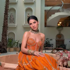 For a vibrant Mehendi or Sangeet, we created this stunning boho-glam look. The makeup is breezy yet impactful, with a dewy base, a fresh flush of peachy warmth, and striking earthy tones on the eyes that are perfect for dancing under fairy lights.