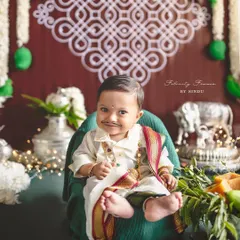 Celebrating Ugadi with the cutest little gentleman! The traditional attire and festive setup, complete with mango leaves and a kolam backdrop, make this a truly special portrait.
