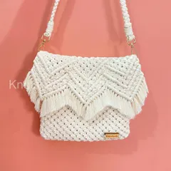 You can't go wrong with a classic! This is my white macrame sling bag, featuring a beautiful chevron pattern and a fringed flap. It's elegant, timeless, and goes with absolutely everything. Like all my bags, it's washable and made to last.