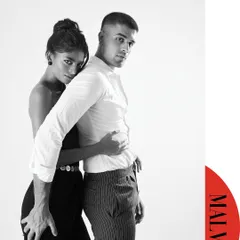 A black and white couple's portrait for a Malvie magazine editorial. The simplicity of the high-key setup and monochrome palette emphasizes the connection and the lines of their bodies. It’s intimate and modern.