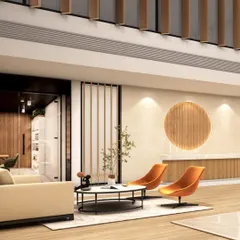 This angle highlights the comfortable seating arrangements in the lobby of The Shri Ram Universal School. The combination of neutral sofas and vibrant orange accent chairs, set against a backdrop of wood and stone, creates a warm and sophisticated waiting experience.