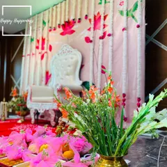 An alternate view of the main stage, showing how the fresh gladiolus flowers and thoughtfully arranged return gifts complement the lotus-themed backdrop. Every element is placed with care to enhance the beauty of the ceremony.