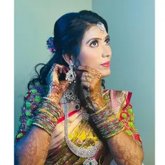 A candid shot of the bride getting ready. This moment captures the final touches, adjusting her beautiful diamond earrings before she makes her grand entrance.