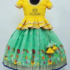 A Zari kota lehenga in a fresh green and yellow combination. The skirt has a colorful printed border, and the yellow peplum top has a delicate scalloped edge.