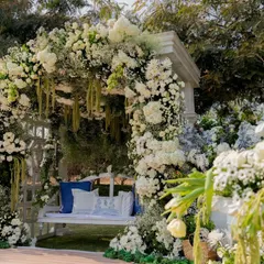 A Haldi ceremony with a twist. We used a sophisticated palette of white, green, and blue for a fresh and modern take on the traditional event. The floral arch over the swing is pure elegance.