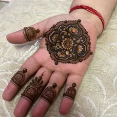 A beautiful shaded floral mandala on the palm with simple finger details, a popular choice for Karwachauth.