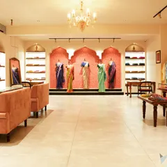 This wide view of the 'House of Vaarasa' boutique showcases our approach to retail design. We created an inviting, luxurious atmosphere with soft lighting, plush seating, and elegant archways that draw customers in and highlight the beauty of the handloom sarees on display.