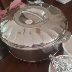 A large insulated casserole used for bulk delivery. We ensure your food stays hot and fresh until it reaches you, whether it's for a small get-together or a large party.