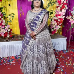 This dark purple lehenga offers a unique and regal alternative to traditional bridal colours. The dense white and gold embroidery creates a stunning contrast, making it a sophisticated choice for a wedding ceremony or a grand reception.