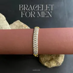 This men's bracelet features a distinctive, diamond-paved chevron pattern set in gold. It is designed for a comfortable, smooth fit, making it a versatile piece that transitions effortlessly from a day at the office to an evening out.