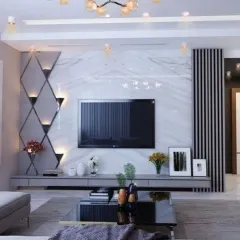 We designed this media wall with a dramatic diamond-patterned mirror accent, which includes integrated sconces for a touch of glamour. The white marble backdrop provides a luxurious contrast to the dark vertical paneling.