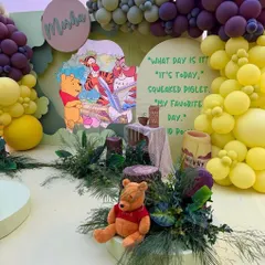Taking a trip to the Hundred Acre Wood for this Winnie the Pooh party. I designed a charming scene with Pooh bear, a themed backdrop, and natural elements like greenery and wood stumps for an authentic feel.