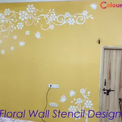 A floral wall stencil design in white applied over a warm yellow background. This cheerful and inviting pattern is perfect for brightening up a living area or entryway.