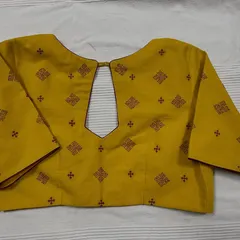 This ready-to-wear mustard yellow cotton blouse features traditional Kasuti embroidery. The motifs are carefully placed to create a design that is both classic and easy to wear, perfect for adding a touch of handcrafted elegance to your wardrobe.