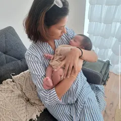 Here I am, sharing a quiet moment with a newborn after a session. Being a mother helps me connect with and soothe babies, ensuring they are always handled with the utmost care and tenderness.