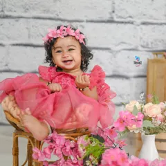 Look at that happy smile! As babies grow, their personalities start to shine. Milestone sessions like this one are perfect for capturing the joy and curiosity of your little one as they sit up and explore the world.
