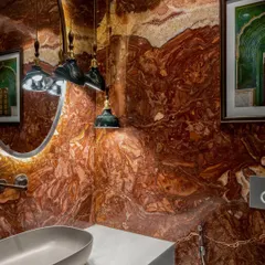 Even the smallest spaces can make the grandest statements. This powder bathroom in a six-bedroom Mumbai home is a symphony of passion and refinement, wrapped in the dramatic veining of red marble. It’s a hidden gem designed to leave a lasting impression.