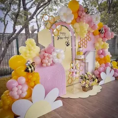 A cheerful "Happy Bee-day" party setup, bursting with yellow and pink balloons, honeycomb details, and cute bee accents. I design these vibrant themes to be fun, playful, and completely photo-ready.