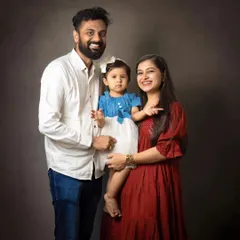 A beautiful family of three posing for a timeless studio portrait. This classic setup is perfect for creating a formal yet warm family heirloom.