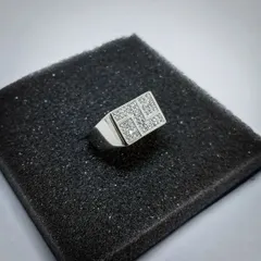 Another angle of the geometric signet ring, showing the depth of the setting and the solid construction of the band. It's a substantial piece built for presence.