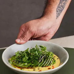 A Plats classic, the Torched Avocado Ceviche. The avocado is lightly charred for a smoky flavor, then served with quinoa, cucumber, and a spicy, tangy passionfruit tigre de leche.