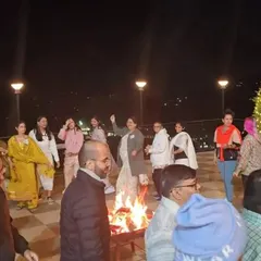 Spirituality is also about joy and community. Here, our group gathers around a warm bonfire at night during the Himachal retreat, sharing stories and laughter under the stars.