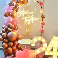 Celebrating love and togetherness with this beautiful anniversary setup. We used rose gold and pink balloons, a 'Better Together' neon sign, and light-up marquee numbers to mark the special occasion.