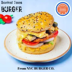 The Smoked Texas Burger from my menu. It features a juicy patty, melted cheese, fresh onions, and tomatoes, all stacked in a sesame seed bun for a truly satisfying burger experience.