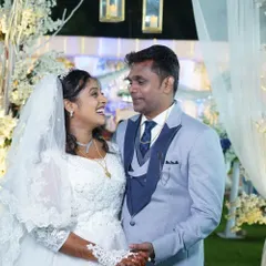 A beautiful, happy moment between the bride and groom. Her makeup is soft and romantic, with a gentle glow that looks perfect in photos.
