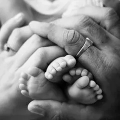 Two sets of tiny feet! This detailed shot of newborn twins' feet held safely in their parents' hands is such an emotional photograph. It's a beautiful way to remember just how small and precious they were.